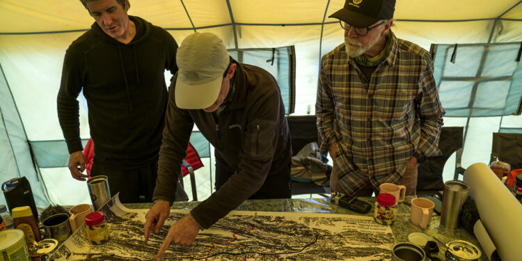 Team members Mark Synnott, Jamie McGuinness, and Thom Pollard map out a plan to climb the North side of Mt. Everest in search of Sandy Irvine's remains. (National Geographic/Renan Ozturk)