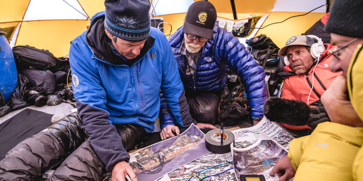 Mark Synnott, Thom Pollard, Jim Hurst, and Jamie McGuinness map out their plan to climb the North side of Mt. Everest in search of Sandy Irvine's remains. (Photograph by Renan Ozturk, National Geographic)
