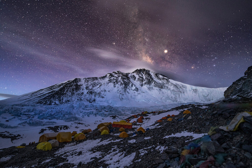 Advanced Base Camp, where more than 200 people sprawl across a quarter mile of glacial moraine. The summit is the rightmost peak, barely visible beyond the snowy saddle of the North Col (at right). (National Geographic/Renan Ozturk)