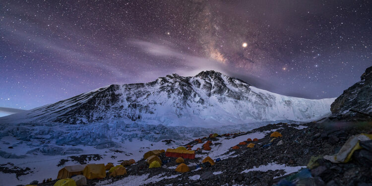 Advanced Base Camp, where more than 200 people sprawl across a quarter mile of glacial moraine. The summit is the rightmost peak, barely visible beyond the snowy saddle of the North Col (at right). (National Geographic/Renan Ozturk)